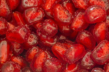 pomegranates seeds covered with water drops