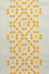 Texture of the vintage homespun linen textile with embroidery. Design of ethnic pattern. Craft...