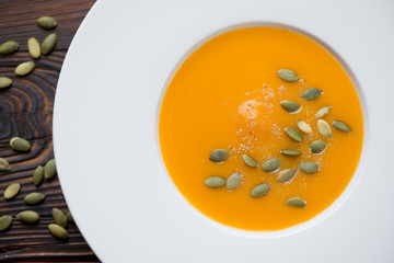 Close-up of pumpkin cream-soup topped with pumpkin seeds