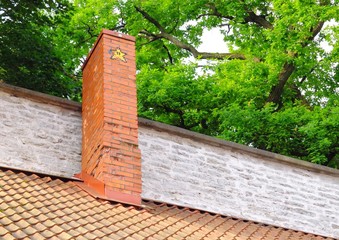 Red brick chimney with a painted yellow star