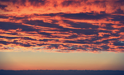 Naklejka na ściany i meble Clouds in the sky at sunset in vintage colors. Beautiful background for your design