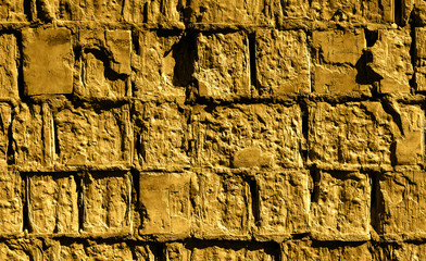 Golden sandy stone brick wall detailed texture background