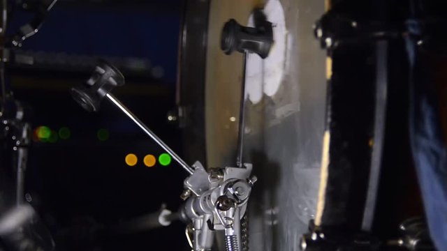 Bass drum pedal while playing the drum kit. Close-up footage