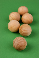 wooden geometric shapes on a green background