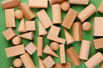 wooden geometric shapes on a green background