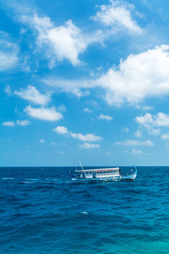 Sea landscape with a traditional Dhoni boat and the clouds, Mald