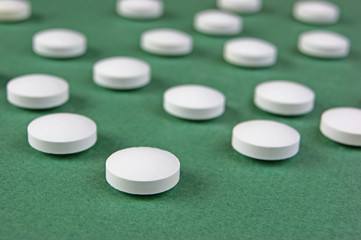 white tablets on a green background
