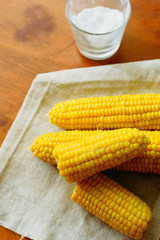 rustic concept just cooked corn with salt on table