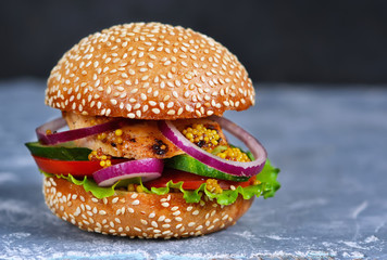 Homemade, big hamburger with meat and fresh vegetables with spac