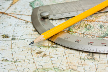 pencil and  protractor on map