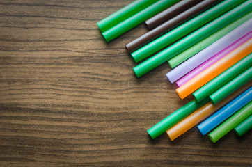 colorful drinking straw on wood board