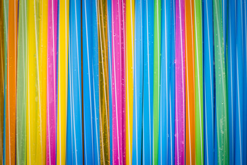 Obraz premium colorful striped drinking straw on wood board