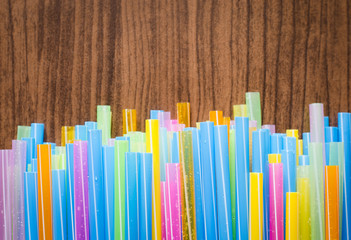 colorful striped drinking straw on wood board