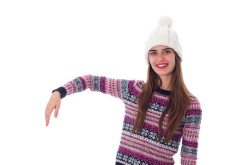 Woman in sweater and white hat holding something 
