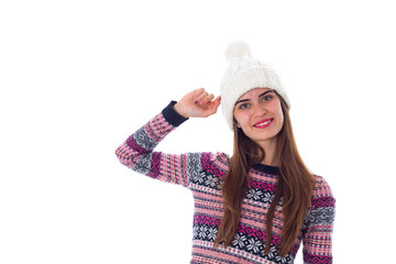 Woman in sweater and white hat holding something 