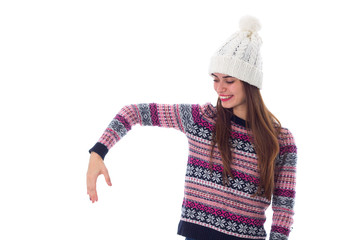 Woman in sweater and white hat holding something 