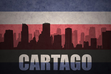 abstract silhouette of the city with text Cartago at the vintage costa rican flag