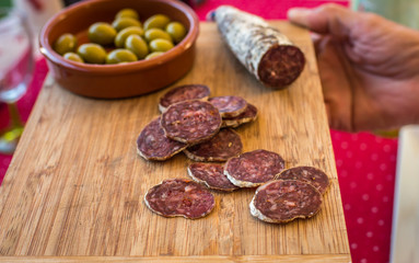 sliced sausage with green olives