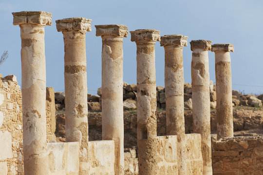 Old columns in a row against a blue sky;Paphos, cyprus