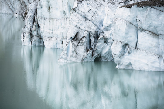 A cliff of ice reflected in a glacial lake, jasper national park;Alberta, canada