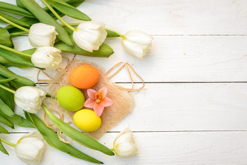 Obraz na płótnie Canvas Color eggs and tulips