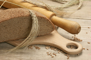 Fototapeta na wymiar rye bread, and corn on a wooden table