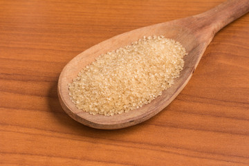 Demerara Sugar into a spoon