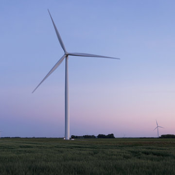 A wind turbine in a field at sunset;Manitoba canada