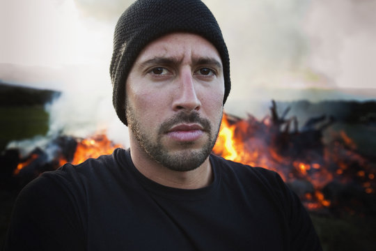 A man standing with a fire burning behind him;Dunsborough west australia australia