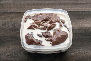 raw turkey liver in milk in plastic container