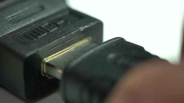 a person inserts a HDMI connector