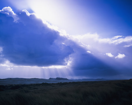 Clouds diffuse the sunlight; Lakeside, Oregon, United States of America