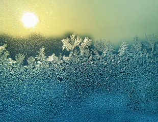 ice patterns and sun on winter glass