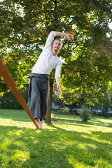 Guy practising slack line in the city park