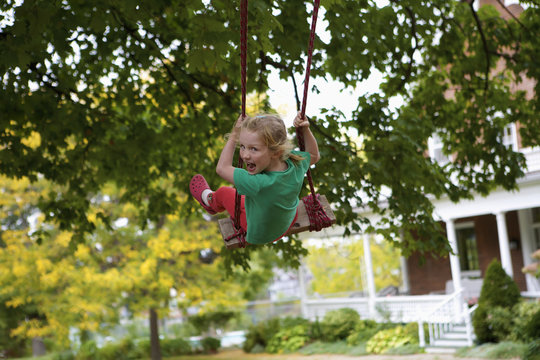Young girl on a swing; Picton, Ontario, Canada