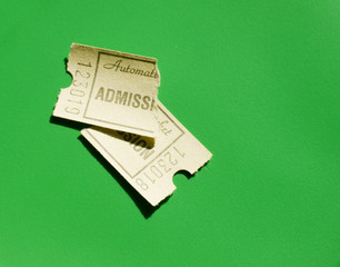 Torn ticket on green background