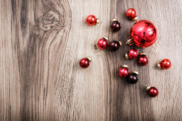 Red Christmas ornaments on a rustic wooden background. Xmas card. Happy New Year. Top view with copy space