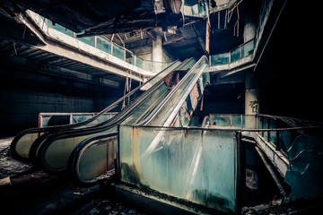 Dramatic view of damaged escalators in abandoned building. Apocalyptic and evil concept