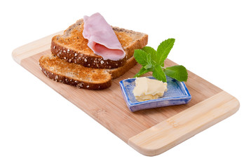 Two slices of bread and butter on wooden board, isolated on white background.