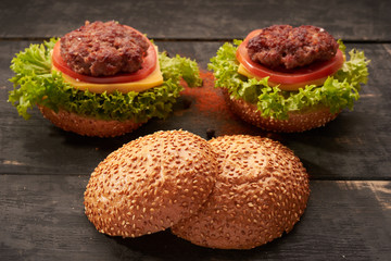 Two hamburger on a wooden table
