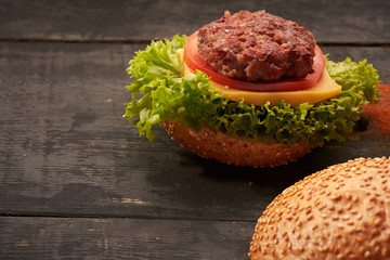 Two hamburger on a wooden table