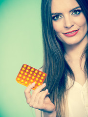 Woman holding pills blister pack vitamin c