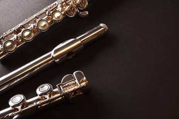 Fototapeta premium Detail of tansverse flute disassembled three parts on black tabl