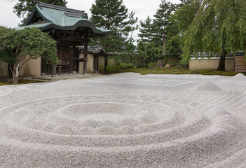 Kyoto, Japan - September 19, 2016: The famous Zen garden at the Kodai-ji Buddhist Temple sits between the hall and the historic main entrance gate. It consists of beige pebbles in geometric figures.