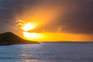 Sunset behind Flat Holm Island in the Bristol Channel. Spectacular sky and clouds seen from Sand Point, north of Weston-super-Mare in Somerset, UK