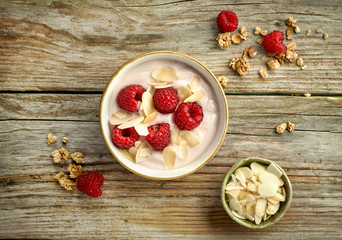 bowl of yogurt with raspberries and almond