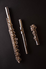 Tansverse flute unmounted into three parts on black table vertic © Davizro Photography