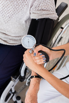 Doctor Checking Blood Pressure Of Patient