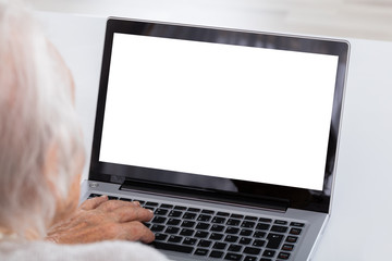 Close-up Of Senior Woman Using Laptop