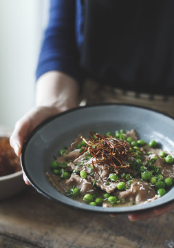 Chestnut flour ravioli with artichokes, peas, broth, and enoki m